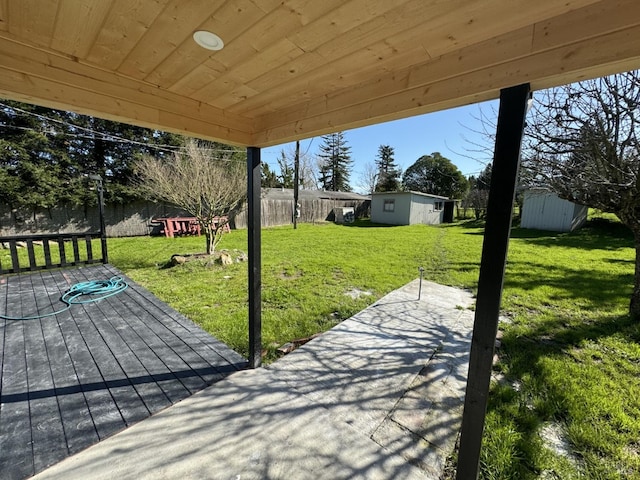 view of patio / terrace featuring a deck and a shed