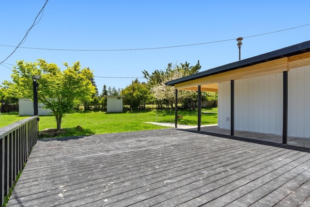 wooden terrace with a storage unit and a yard