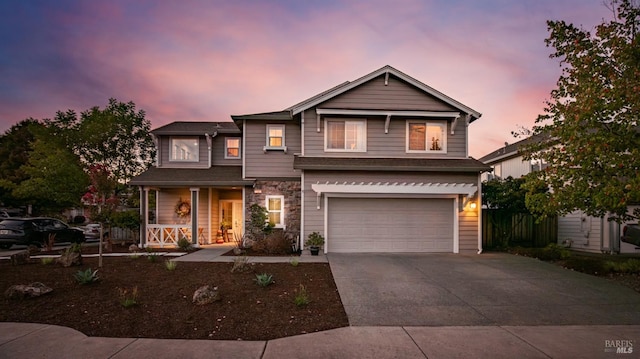 view of front of property with a porch and a garage