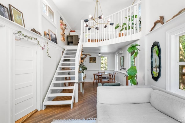 living room with a wealth of natural light, a chandelier, and hardwood / wood-style floors