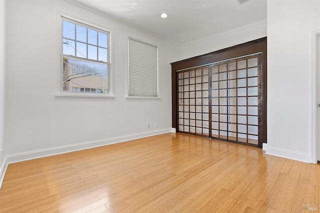 unfurnished room featuring light hardwood / wood-style flooring and ornamental molding