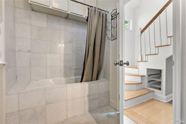 bathroom featuring shower / bathtub combination with curtain and tile patterned flooring