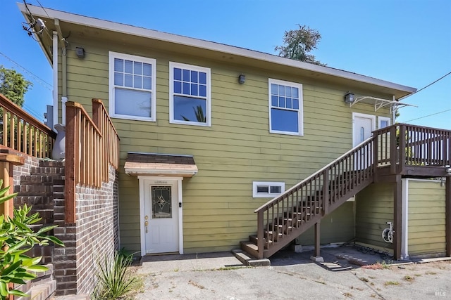 back of property featuring a deck