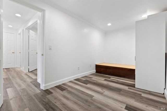 empty room featuring light hardwood / wood-style flooring and ornamental molding