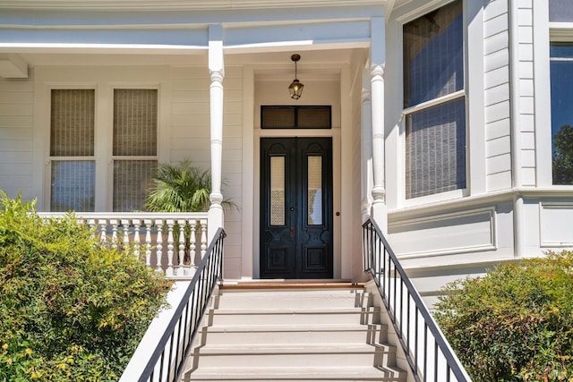 view of exterior entry featuring a porch