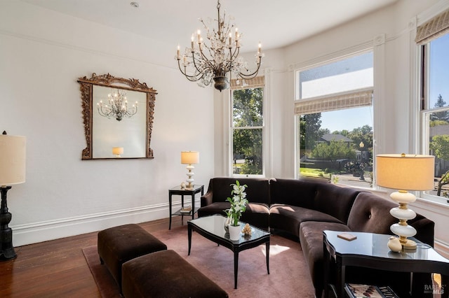 living room with wood-type flooring, a chandelier, and a wealth of natural light