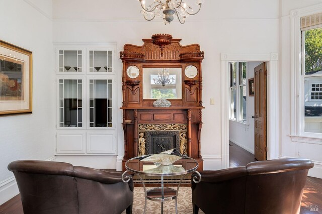 2230 1st St, Napa, CA 94559 - living area with dark wood-style flooring, baseboards, an inviting chandelier, and a large fireplace