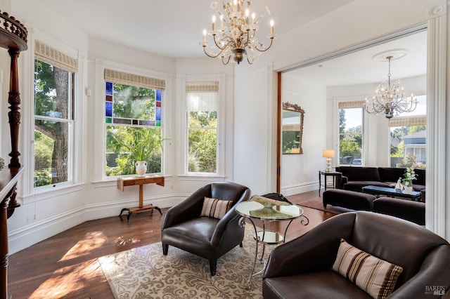 sitting room featuring a notable chandelier, a wealth of natural light, and wood-type flooring