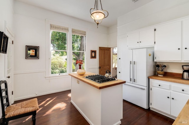 kitchen with white cabinetry, dark hardwood / wood-style flooring, pendant lighting, white fridge, and wood counters