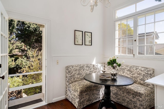 dining room featuring dark wood-type flooring, baseboards, and an inviting chandelier