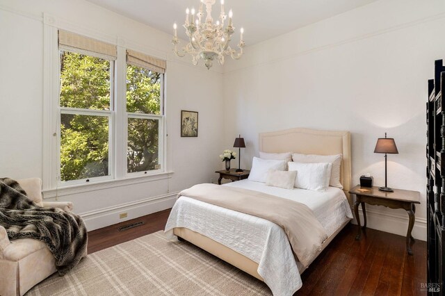 2230 1st St, Napa, CA 94559 - bedroom featuring baseboards, an inviting chandelier, wood finished floors, and visible vents