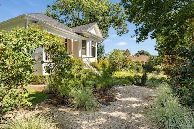 view of property exterior featuring a shingled roof