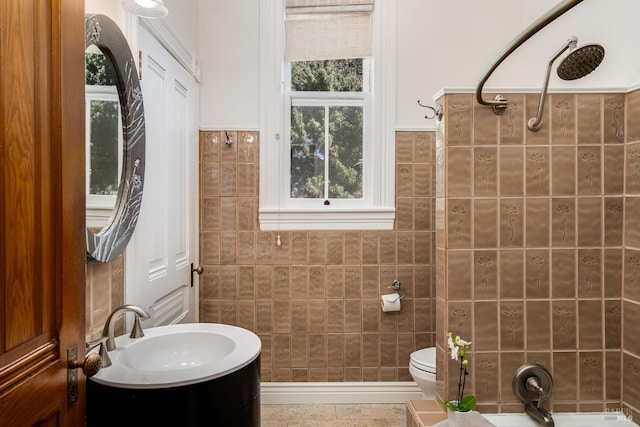 bathroom featuring tile walls, tile patterned flooring, a shower, vanity, and toilet