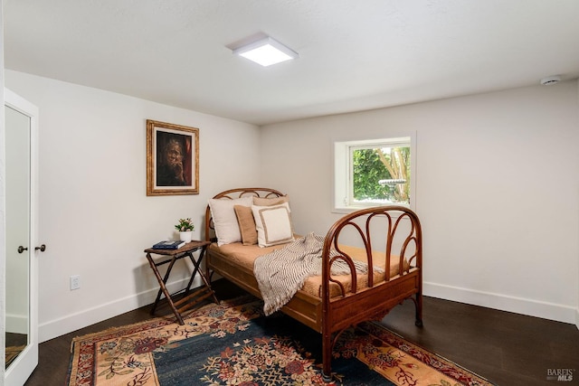 bedroom featuring dark hardwood / wood-style flooring