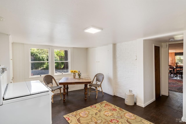 dining area featuring dark wood-type flooring