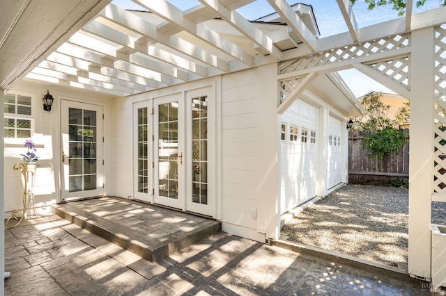 view of patio with a pergola, fence, and a garage