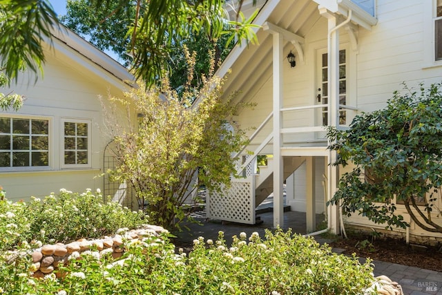 view of side of home featuring stairs