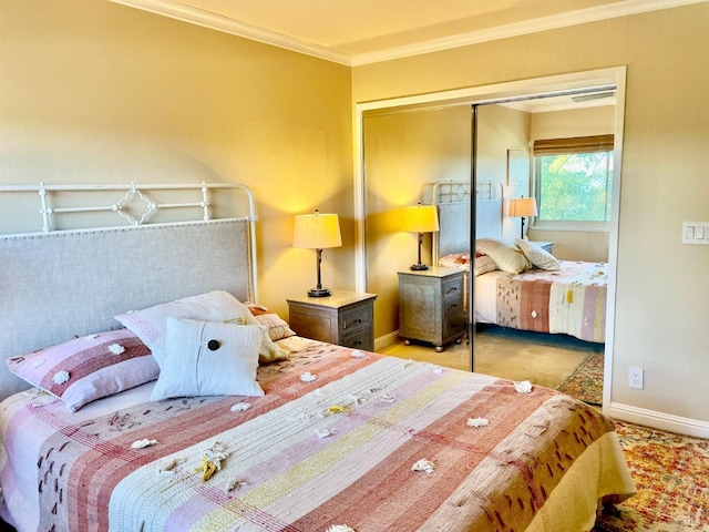 carpeted bedroom featuring a closet, baseboards, and crown molding