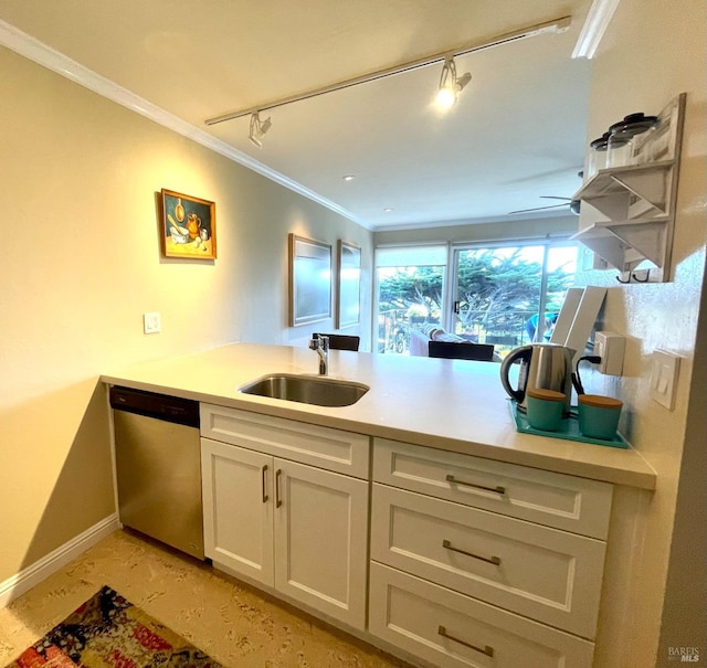 kitchen with a peninsula, a sink, white cabinets, ornamental molding, and dishwasher