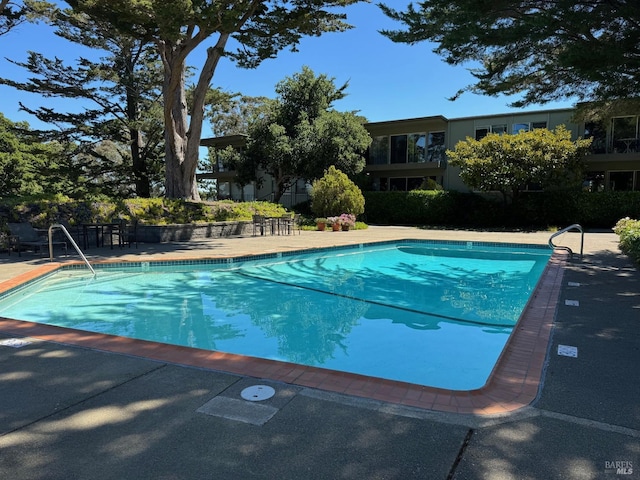 community pool featuring a patio area