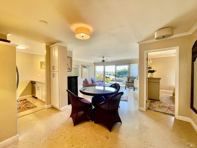 dining area with ornamental molding and a fireplace