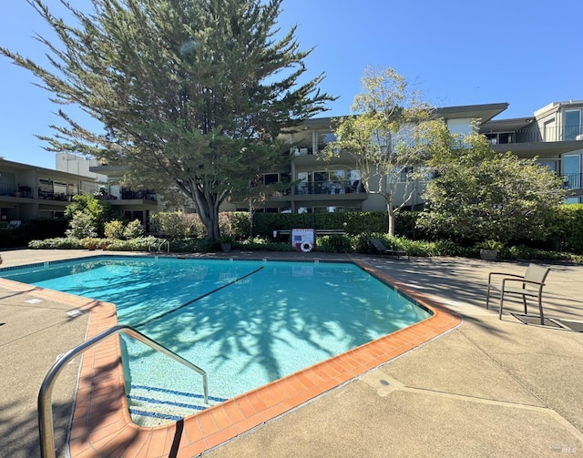 community pool featuring a patio area