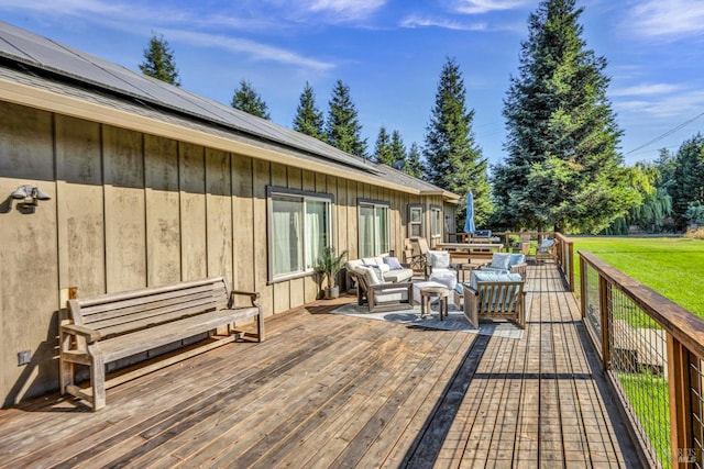 wooden terrace with outdoor lounge area and a yard