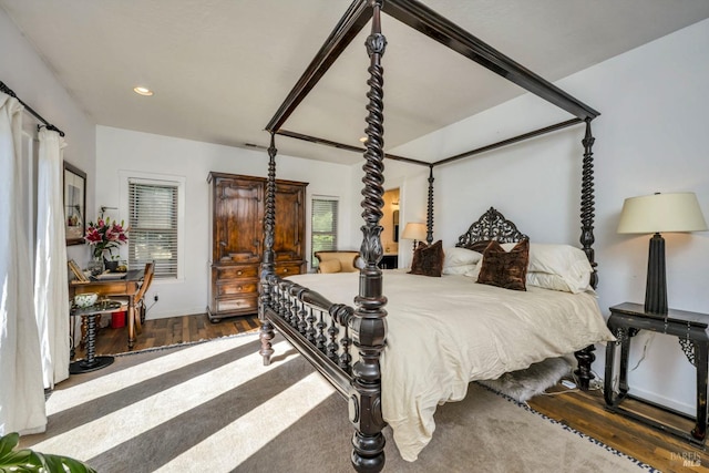 bedroom with hardwood / wood-style flooring and multiple windows