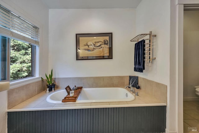 bathroom with a bathtub, tile patterned flooring, and toilet