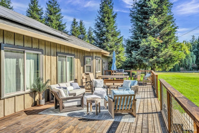 wooden terrace featuring an outdoor hangout area and a lawn