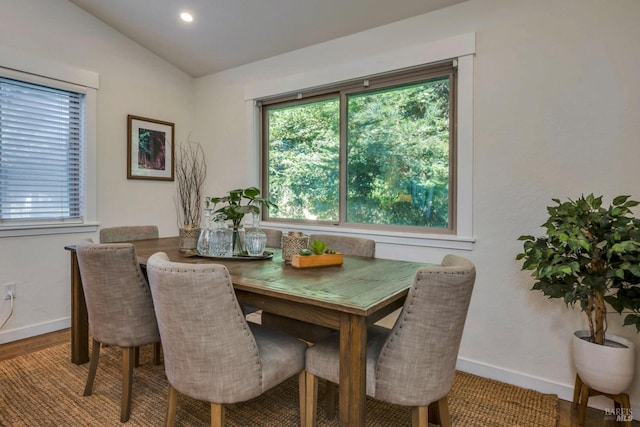 dining space featuring lofted ceiling and hardwood / wood-style floors