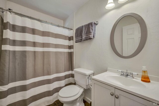 bathroom featuring vanity and toilet