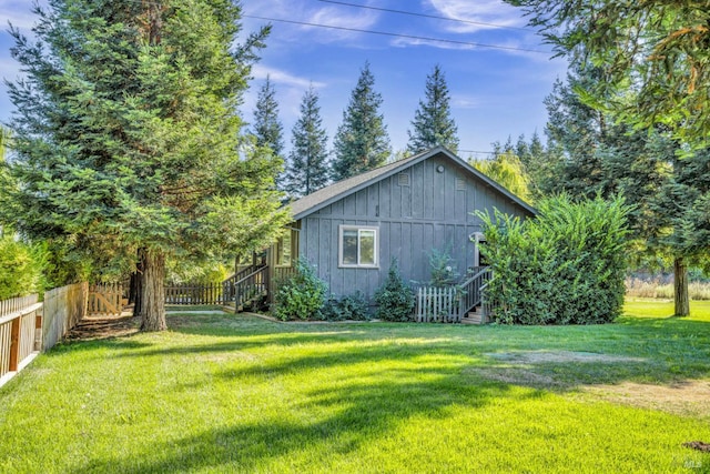 view of side of home with a lawn