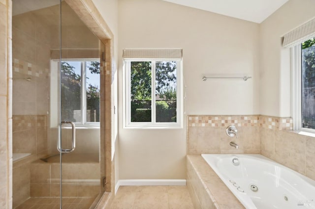 bathroom with shower with separate bathtub, vaulted ceiling, and tile patterned floors