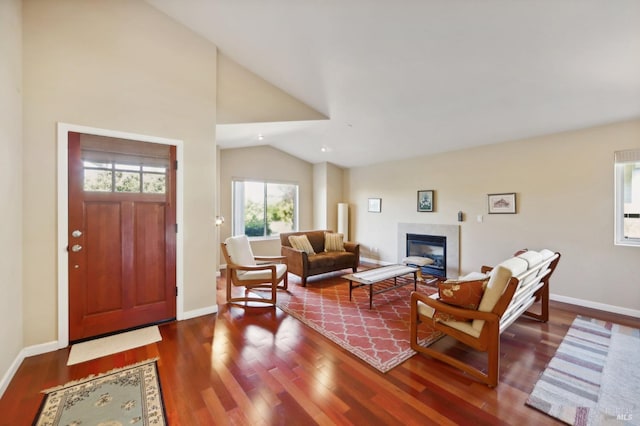 foyer entrance with hardwood / wood-style flooring and vaulted ceiling