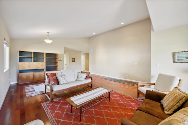 living room featuring lofted ceiling and hardwood / wood-style flooring