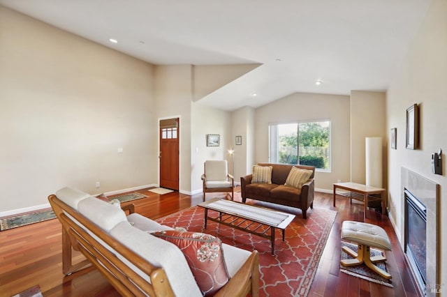 living room featuring wood-type flooring, a fireplace, and lofted ceiling