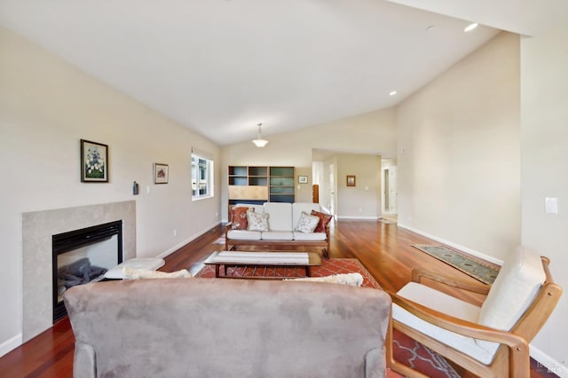 living room featuring lofted ceiling, a premium fireplace, and dark hardwood / wood-style floors