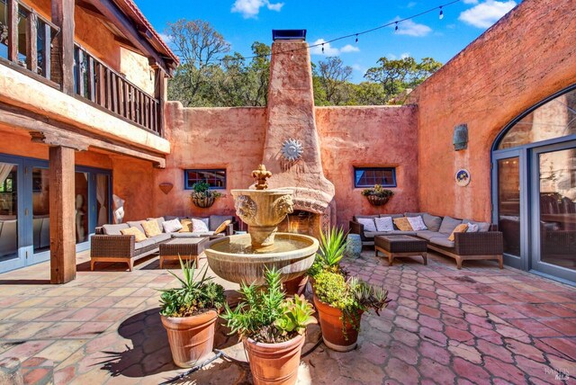 view of patio featuring a balcony and an outdoor living space