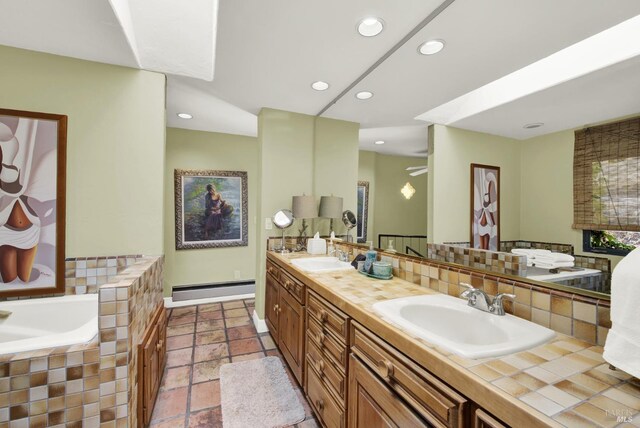 bathroom with a relaxing tiled tub, vanity, and baseboard heating