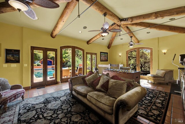 tiled living room featuring vaulted ceiling with beams, ceiling fan, and french doors