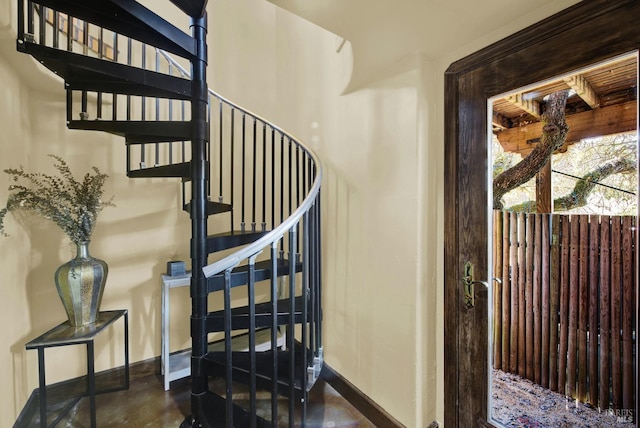 staircase featuring concrete flooring