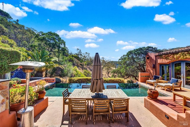 view of swimming pool with french doors and a patio