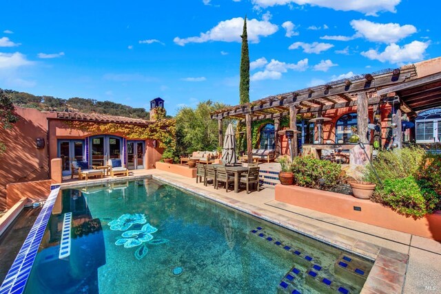 view of pool with a pergola, a patio area, french doors, and an outdoor hangout area