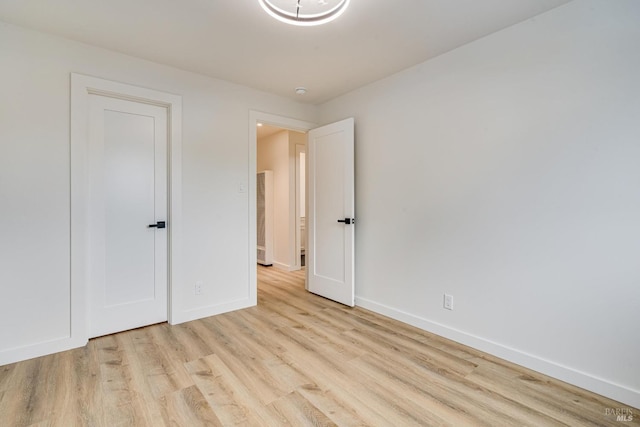 unfurnished bedroom with baseboards and wood finished floors