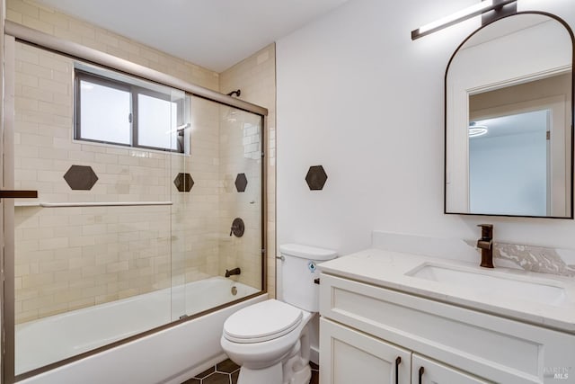 full bathroom featuring tile patterned flooring, vanity, enclosed tub / shower combo, and toilet