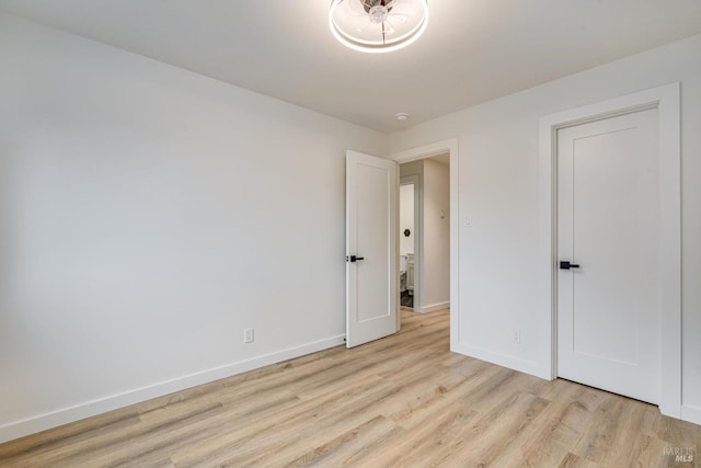 unfurnished bedroom featuring baseboards and light wood-style floors