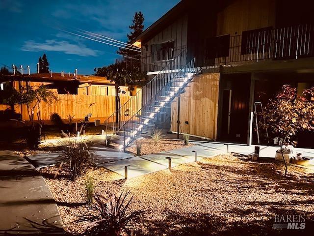 view of side of home featuring stairway