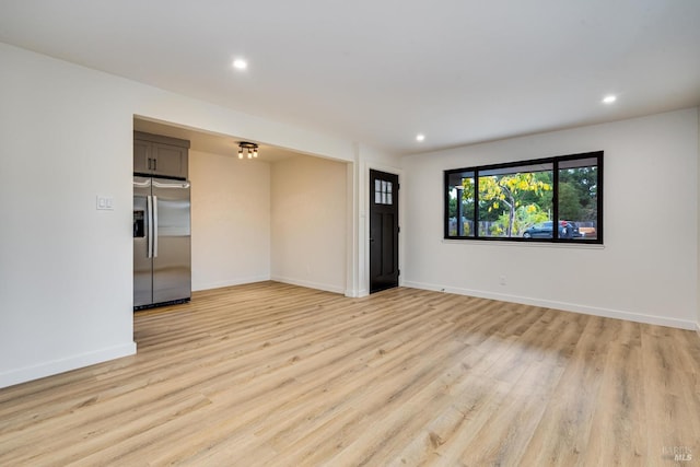 unfurnished room featuring baseboards, light wood-type flooring, and recessed lighting