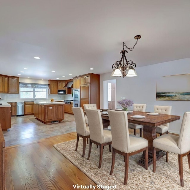 10951 River Rd, Courtland, CA 95615 - dining room featuring light wood-type flooring and a notable chandelier